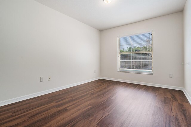 12421 Seabrook Dr, Tampa, FL 33626 - unfurnished room with baseboards and dark wood-type flooring