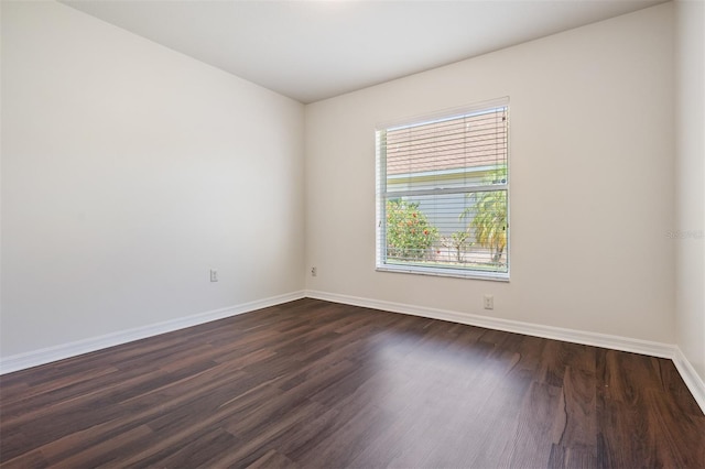 12421 Seabrook Dr, Tampa, FL 33626 - unfurnished room with baseboards and dark wood-type flooring