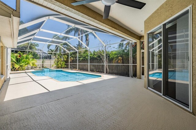 12421 Seabrook Dr, Tampa, FL 33626 - view of swimming pool featuring a patio area, ceiling fan, a fenced backyard, and glass enclosure