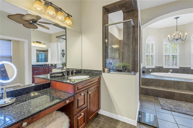 full bathroom featuring a stall shower, tile patterned flooring, a bath, a chandelier, and vanity