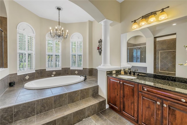 bathroom with decorative columns, healthy amount of natural light, a garden tub, and tiled shower