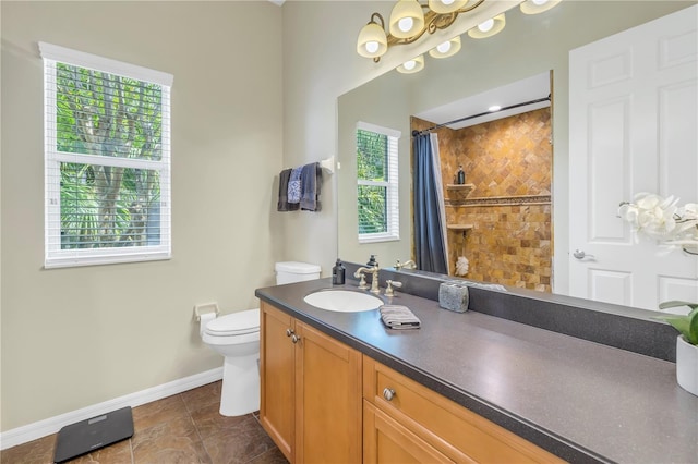 bathroom with baseboards, toilet, vanity, a shower with shower curtain, and tile patterned floors