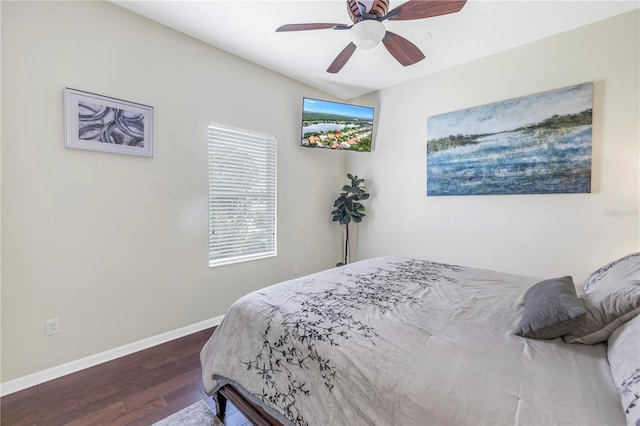 bedroom with wood finished floors, baseboards, and ceiling fan