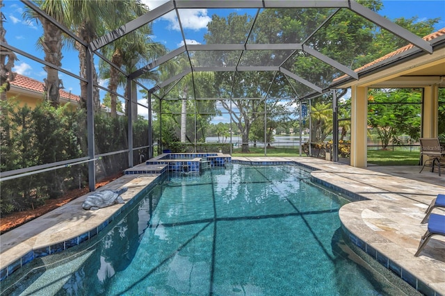 view of pool with a patio, a pool with connected hot tub, and a lanai