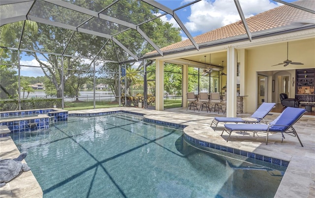 view of pool featuring ceiling fan, a patio, a pool with connected hot tub, and glass enclosure