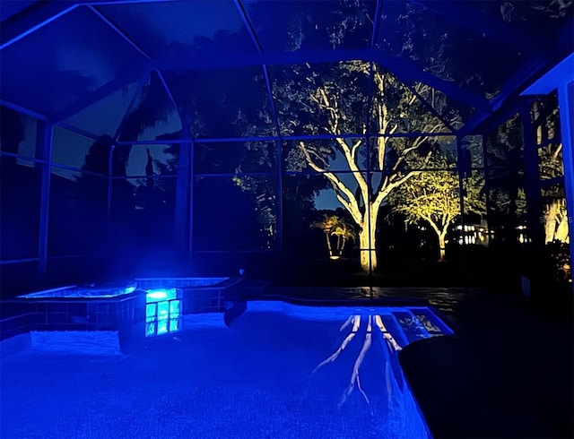 swimming pool with a jacuzzi and a lanai