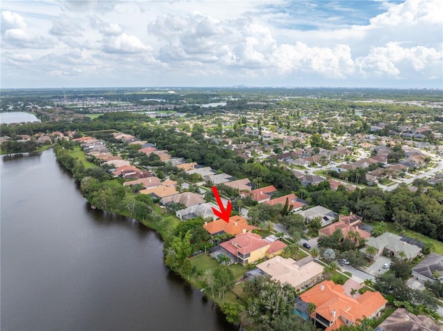 view of property location featuring a nearby body of water and nearby suburban area
