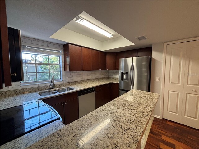 14446 Reuter Strasse Cir Unit 3, Tampa, FL 33613 - kitchen featuring appliances with stainless steel finishes, a sink, dark wood finished floors, light stone counters, and dark brown cabinetry