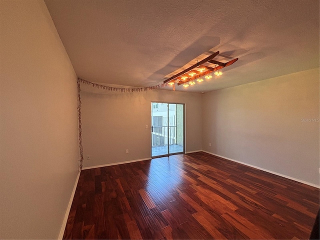 14446 Reuter Strasse Cir Unit 3, Tampa, FL 33613 - unfurnished room with dark wood finished floors, baseboards, a textured ceiling, and ceiling fan