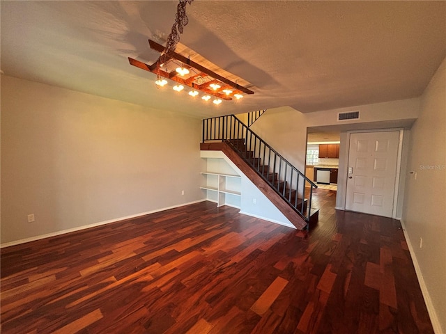 14446 Reuter Strasse Cir Unit 3, Tampa, FL 33613 - unfurnished living room with stairway, wood finished floors, baseboards, a chandelier, and a fireplace
