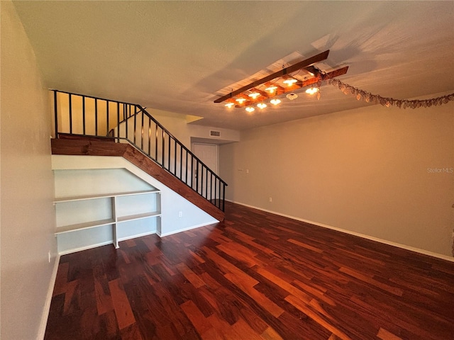 14446 Reuter Strasse Cir Unit 3, Tampa, FL 33613 - unfurnished living room featuring wood finished floors, stairway, and baseboards