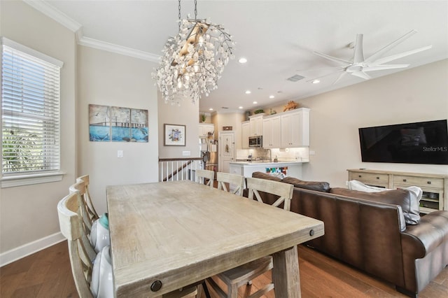 6140 Marina Cove Way S, Saint Petersburg, FL 33712 - dining space with dark wood finished floors, a ceiling fan, healthy amount of natural light, crown molding, and recessed lighting