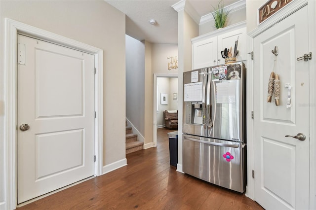 6140 Marina Cove Way S, Saint Petersburg, FL 33712 - kitchen with stainless steel refrigerator with ice dispenser, white cabinets, dark wood-style floors, baseboards, and crown molding