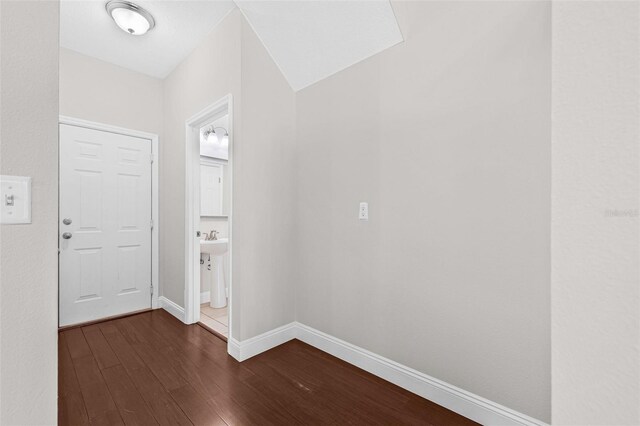 foyer entrance with dark wood-type flooring and baseboards