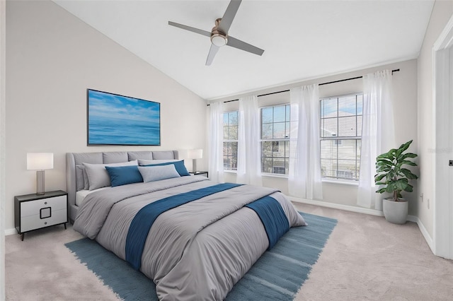 bedroom with light carpet, baseboards, vaulted ceiling, and a ceiling fan