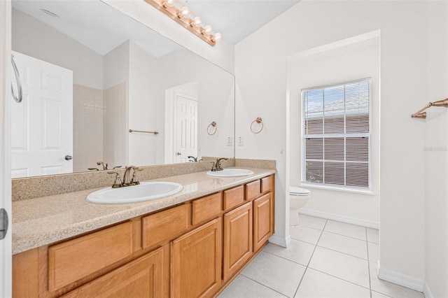 full bath featuring tile patterned flooring, baseboards, toilet, and double vanity