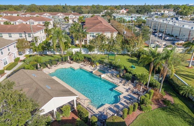 community pool featuring a patio and fence