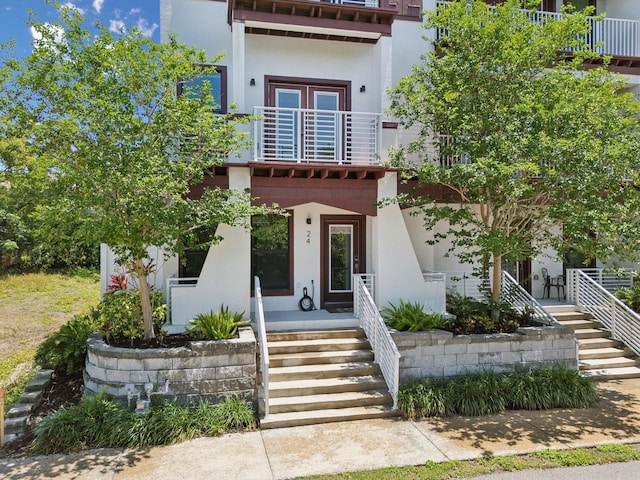 946 Highland Ave Unit 24, Dunedin, FL 34698 - view of front of house featuring a balcony, stairway, stucco siding, and a porch