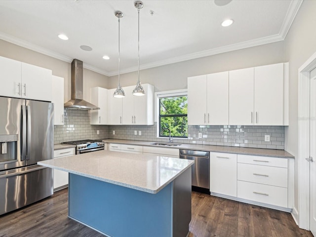 946 Highland Ave Unit 24, Dunedin, FL 34698 - kitchen with stainless steel appliances, wall chimney exhaust hood, dark wood-style flooring, decorative light fixtures, and ornamental molding