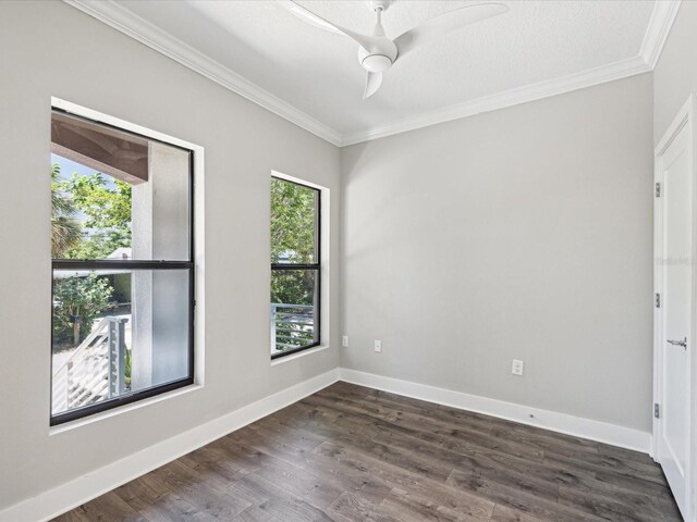 946 Highland Ave Unit 24, Dunedin, FL 34698 - spare room featuring crown molding, dark wood-style flooring, a ceiling fan, and baseboards
