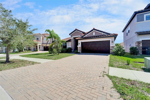12055 Cardinal Flower Dr, Riverview, FL 33579 - view of front facade with decorative driveway, an attached garage, stucco siding, a tiled roof, and a front yard