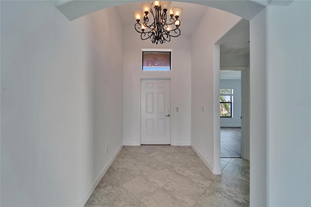 12055 Cardinal Flower Dr, Riverview, FL 33579 - foyer with arched walkways, a chandelier, and baseboards