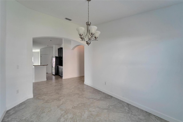 12055 Cardinal Flower Dr, Riverview, FL 33579 - unfurnished room with arched walkways, a chandelier, and baseboards