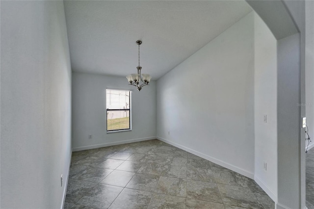 12055 Cardinal Flower Dr, Riverview, FL 33579 - unfurnished room featuring arched walkways, a chandelier, and baseboards