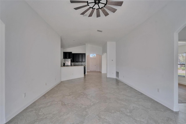 12055 Cardinal Flower Dr, Riverview, FL 33579 - unfurnished living room featuring arched walkways, lofted ceiling, a ceiling fan, and baseboards