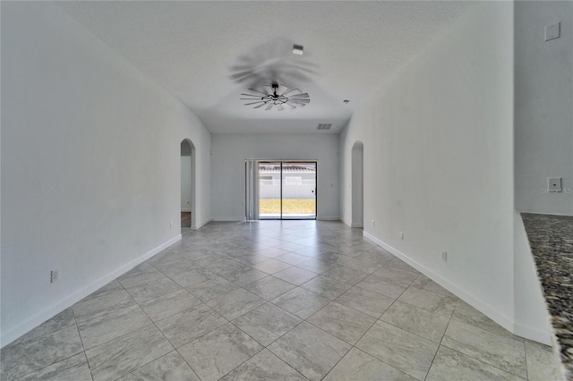 12055 Cardinal Flower Dr, Riverview, FL 33579 - empty room featuring arched walkways, a ceiling fan, baseboards, and light tile patterned floors