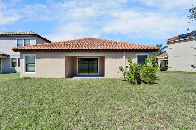 12055 Cardinal Flower Dr, Riverview, FL 33579 - back of house featuring stucco siding, a yard, and a tiled roof