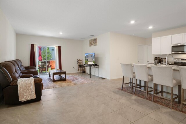 2449 Moon Shadow Rd, New Port Richey, FL 34655 - living room featuring recessed lighting and light tile patterned floors