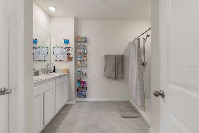 2449 Moon Shadow Rd, New Port Richey, FL 34655 - bathroom featuring a stall shower, double vanity, tile patterned floors, and baseboards