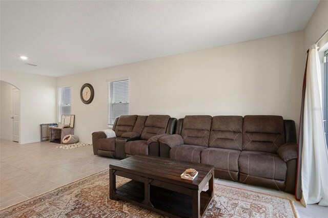 2449 Moon Shadow Rd, New Port Richey, FL 34655 - living room with arched walkways, tile patterned floors, recessed lighting, and baseboards