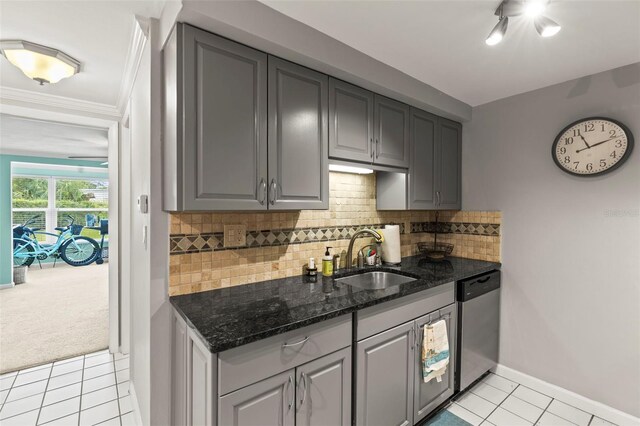 kitchen featuring dishwasher, a sink, gray cabinets, light tile patterned floors, and crown molding