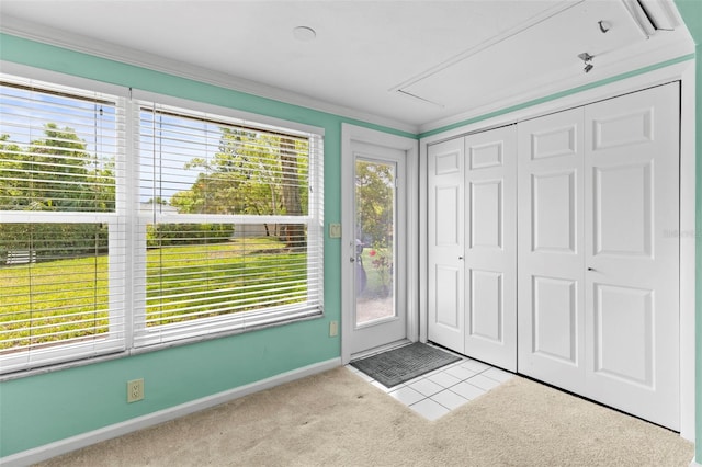 carpeted foyer entrance with baseboards and crown molding