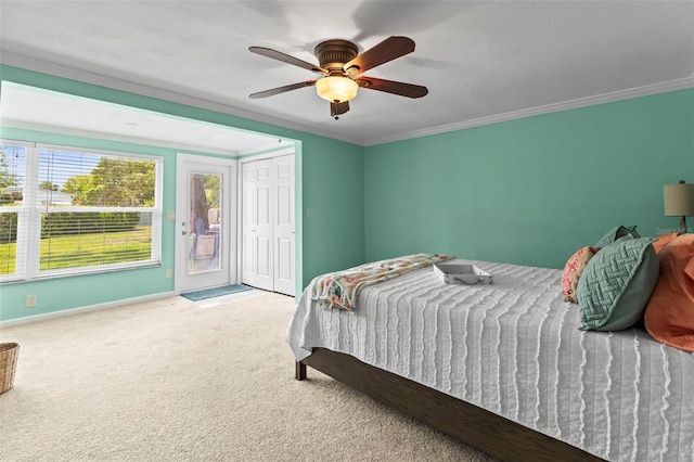 carpeted bedroom featuring ornamental molding, baseboards, and ceiling fan