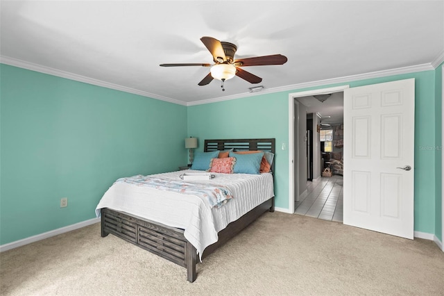 bedroom with carpet, baseboards, crown molding, and ceiling fan