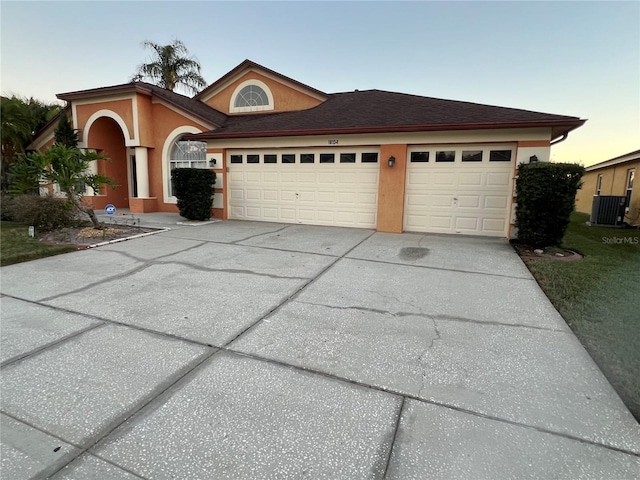 18104 Sweet Jasmine Dr, Tampa, FL 33647 - view of front of property featuring driveway, a garage, and stucco siding