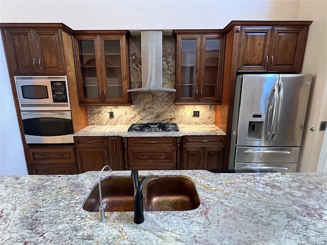 18104 Sweet Jasmine Dr, Tampa, FL 33647 - kitchen with appliances with stainless steel finishes, wall chimney exhaust hood, and light stone countertops
