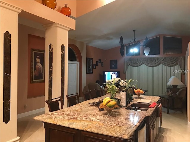 18104 Sweet Jasmine Dr, Tampa, FL 33647 - kitchen featuring vaulted ceiling, light stone counters, a kitchen island with sink, decorative columns, and dishwasher