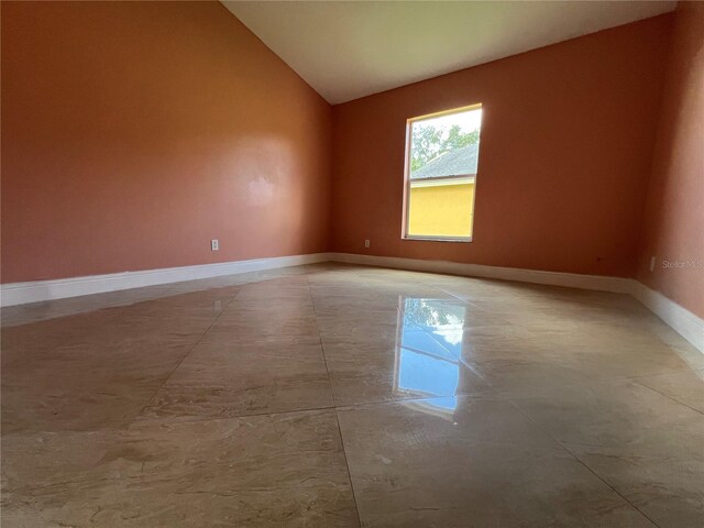 18104 Sweet Jasmine Dr, Tampa, FL 33647 - empty room with vaulted ceiling and baseboards