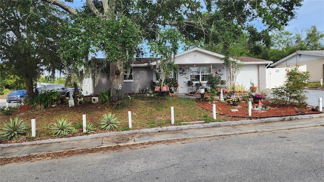 view of front facade featuring a garage and fence