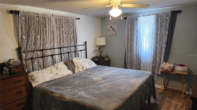 bedroom with wood finished floors and a ceiling fan