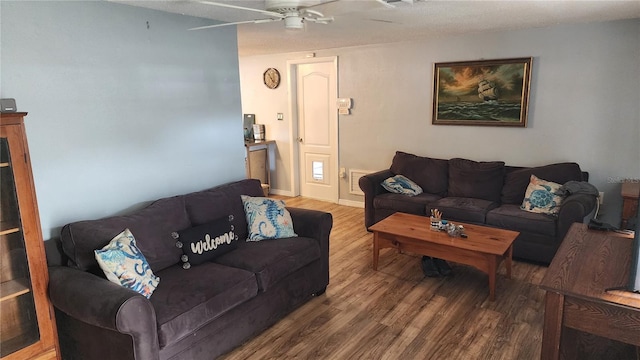 living area featuring wood finished floors and a ceiling fan