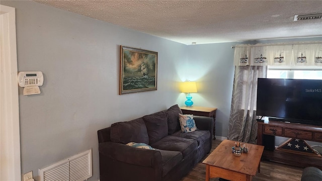 living area with wood finished floors and a textured ceiling
