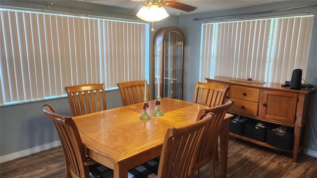 dining space with dark wood-style flooring, baseboards, and a ceiling fan