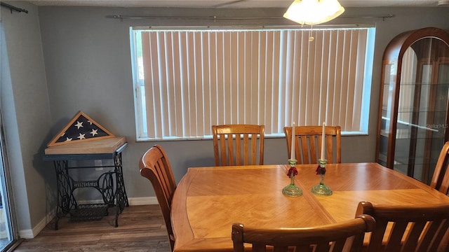 dining space with wood finished floors and baseboards