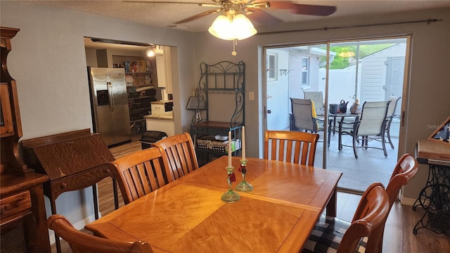 dining room featuring ceiling fan and wood finished floors