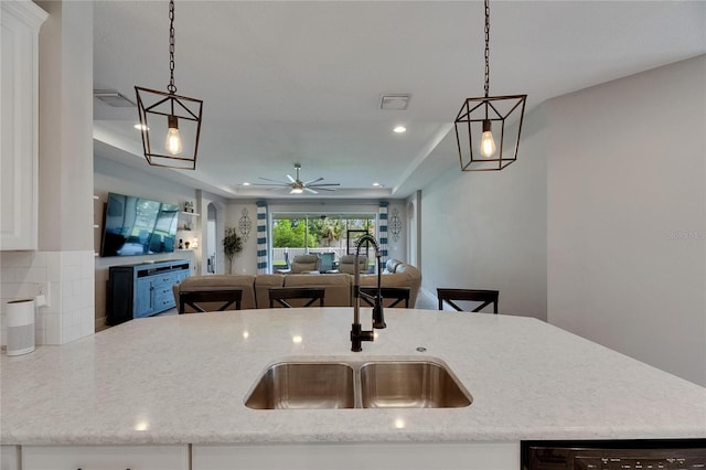 kitchen featuring a sink, recessed lighting, decorative light fixtures, a ceiling fan, and open floor plan